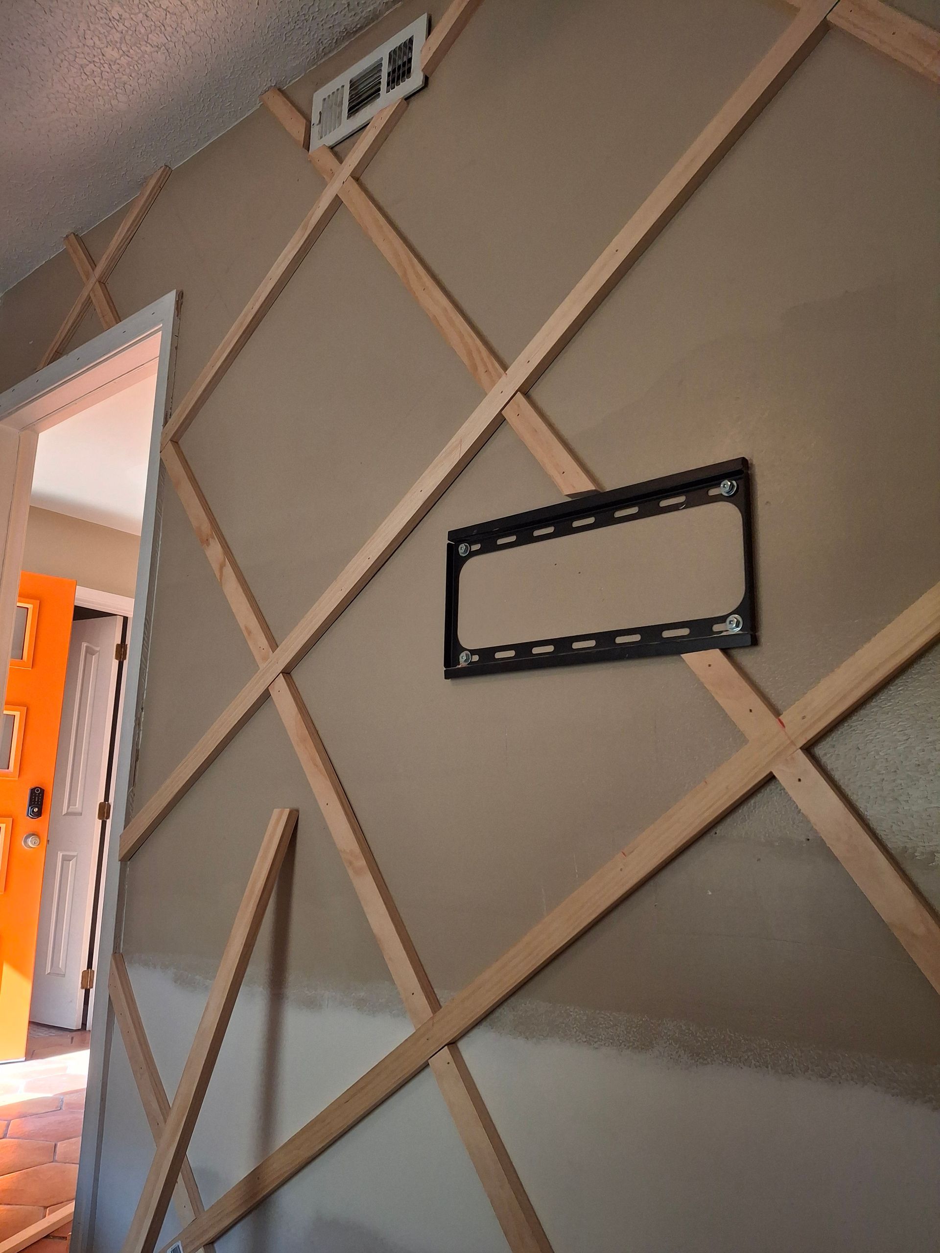 A picture frame is hanging on a wall in a room