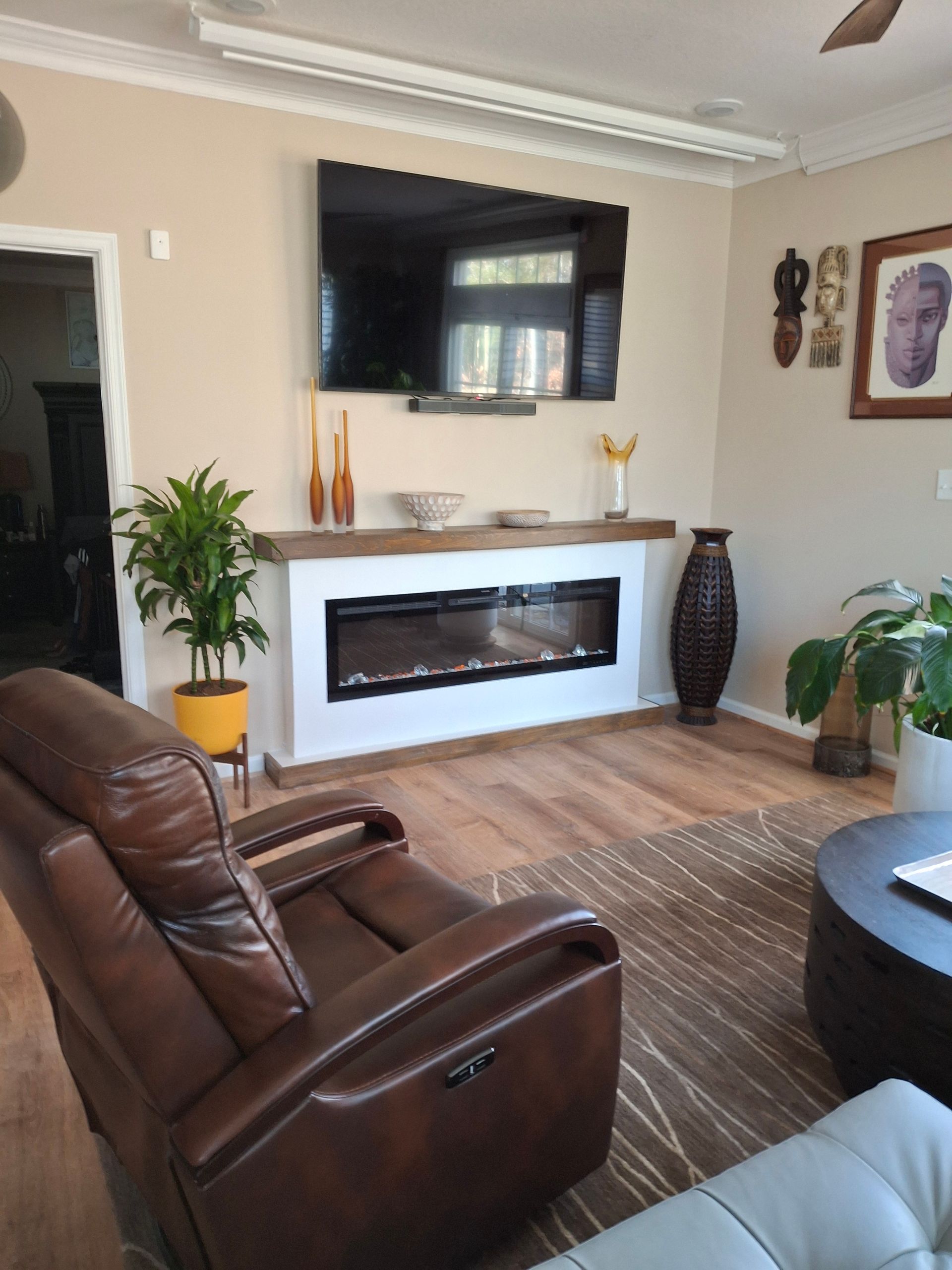 A living room with a fireplace and a flat screen tv