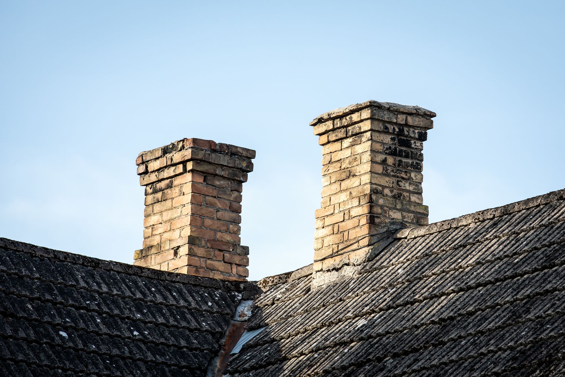House with a tiled roof and chimney in a quiet suburban setting under a cloudy sky House with a tiled roof and chimney in a quiet suburban setting under a cloudy sky