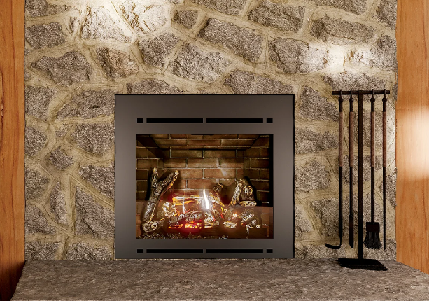 Stone fireplace with a lit fire, dark metal screen, and fireplace tools beside it. Stone fireplace with a lit fire, dark metal screen, and fireplace tools beside it.