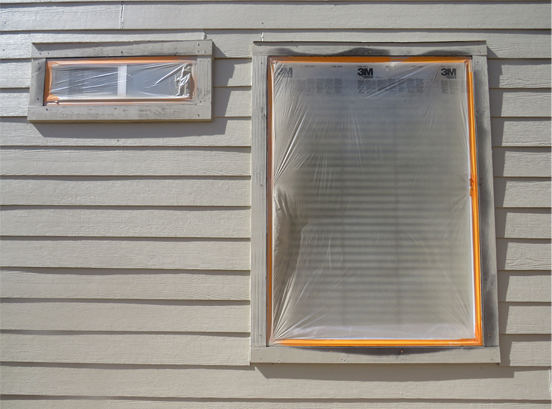 windows taped during house painting