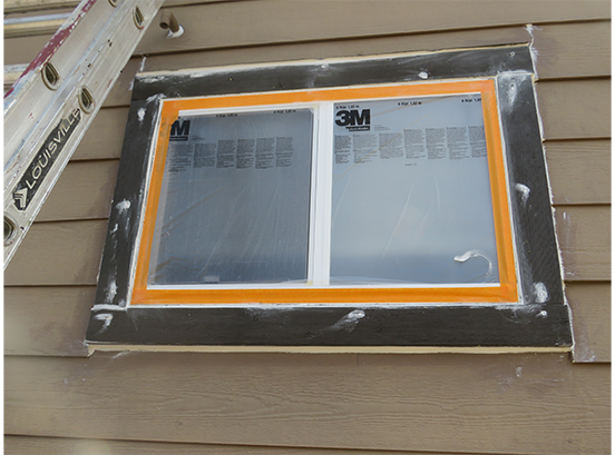prepping windows on house before painting