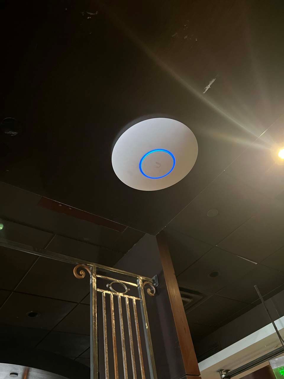 A white circle with a blue circle on it is hanging from the ceiling.