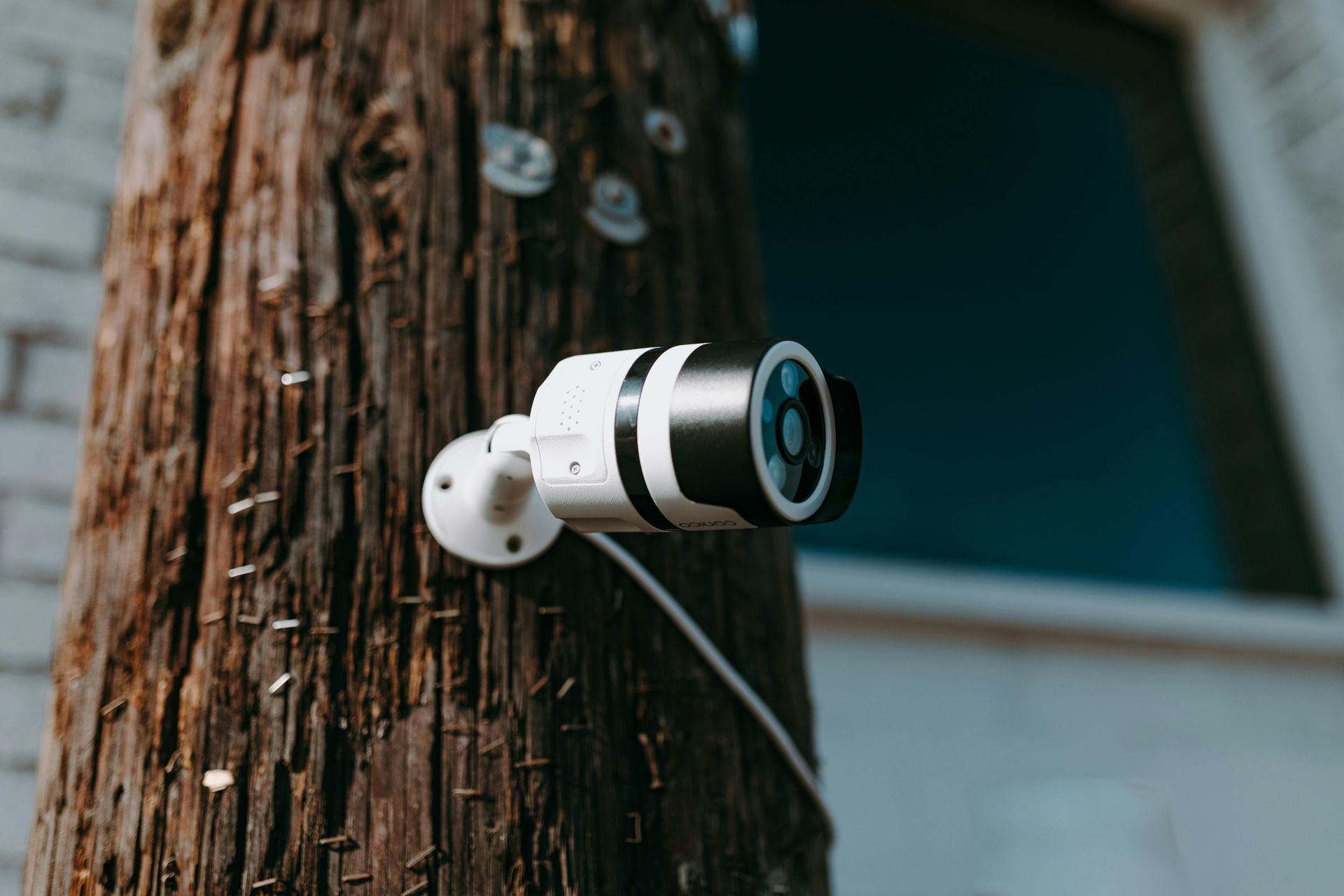 A security camera is mounted on the side of a building