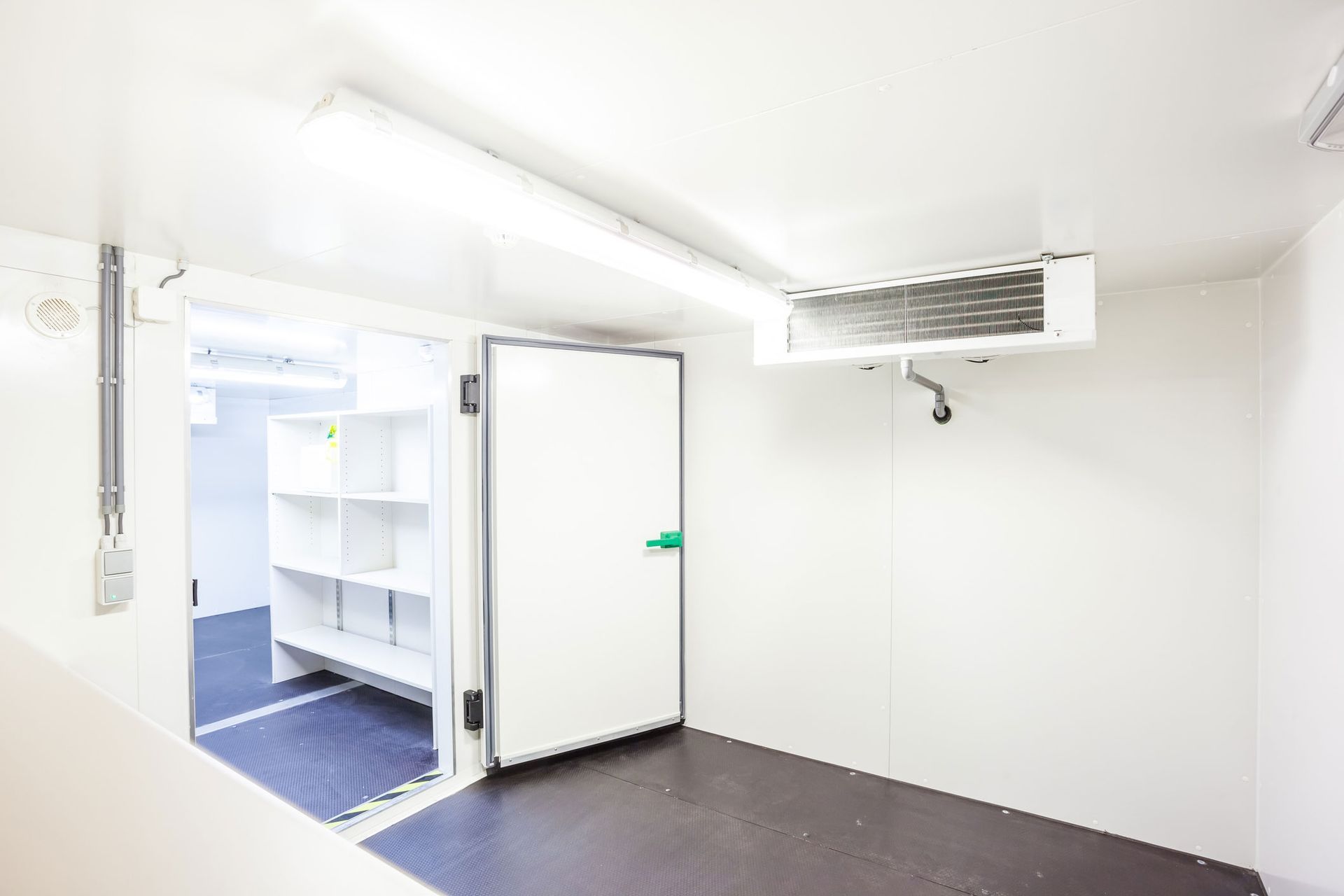 An empty cool room refrigerator with four fans