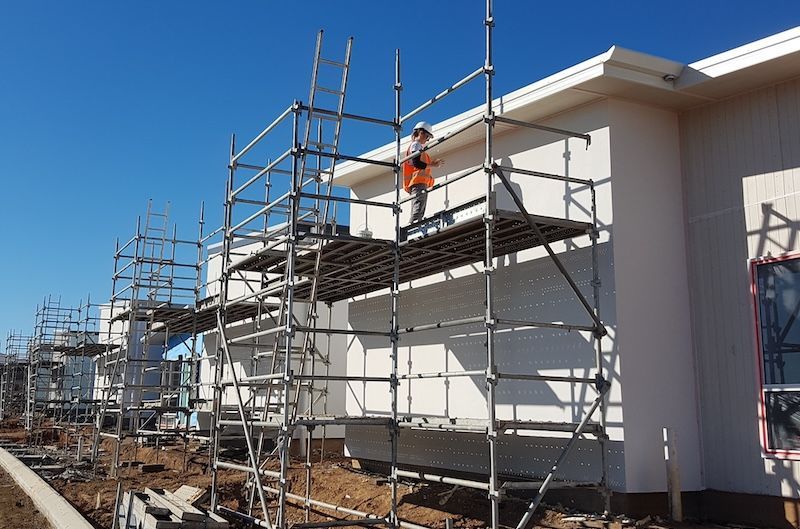 A Person Is Spraying Powder Paint on A Piece of Metal — A Brush With Colour in Wondunna, QLD