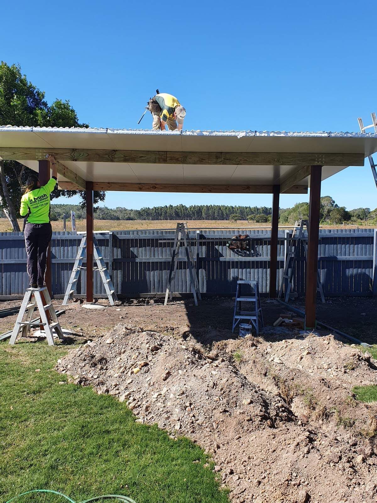 A Man Is Painting the Side of A House — A Brush With Colour in Torquay, QLD