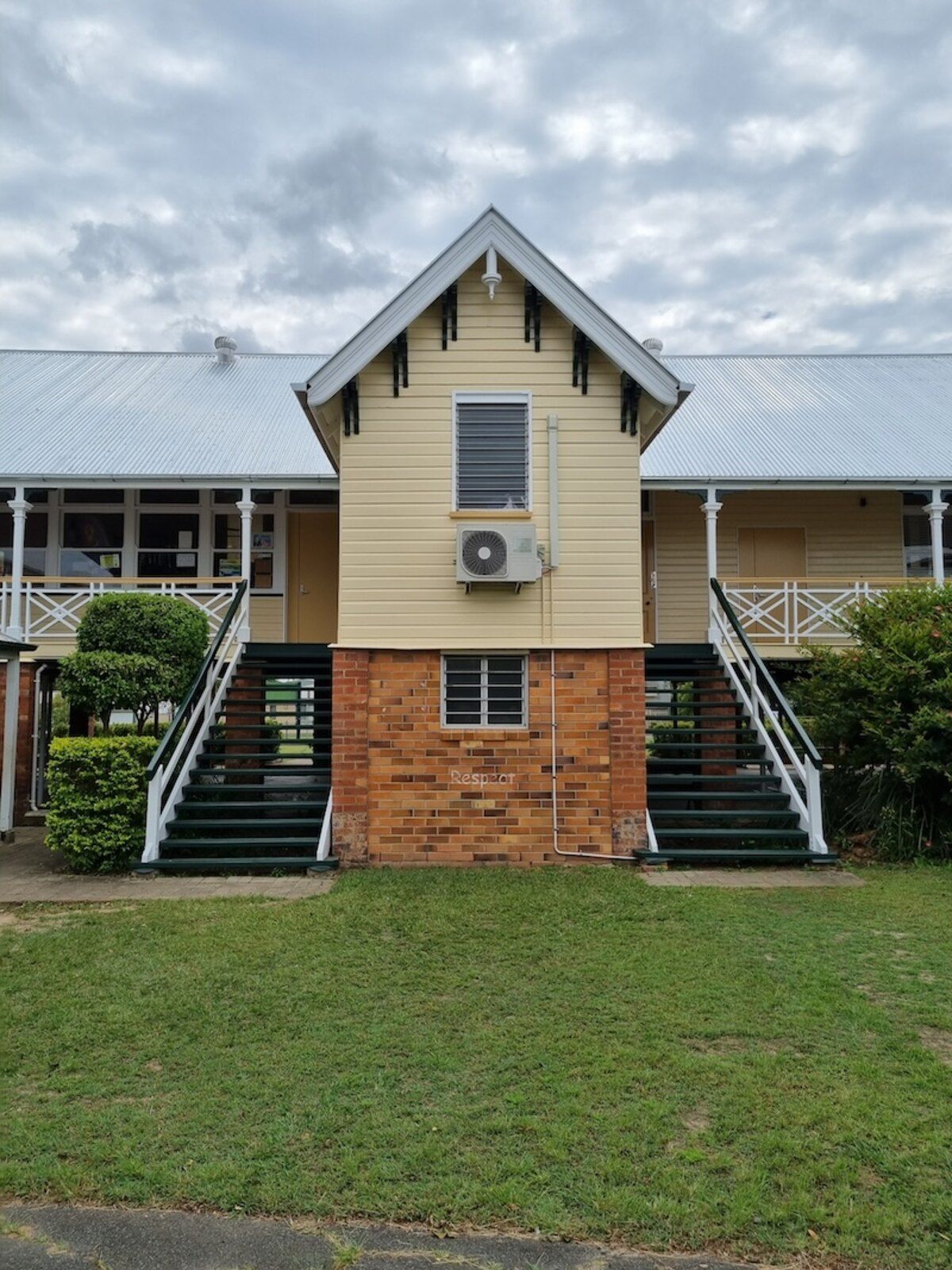 A Man Is Working on The Roof of A Building — A Brush With Colour in Urraween, QLD