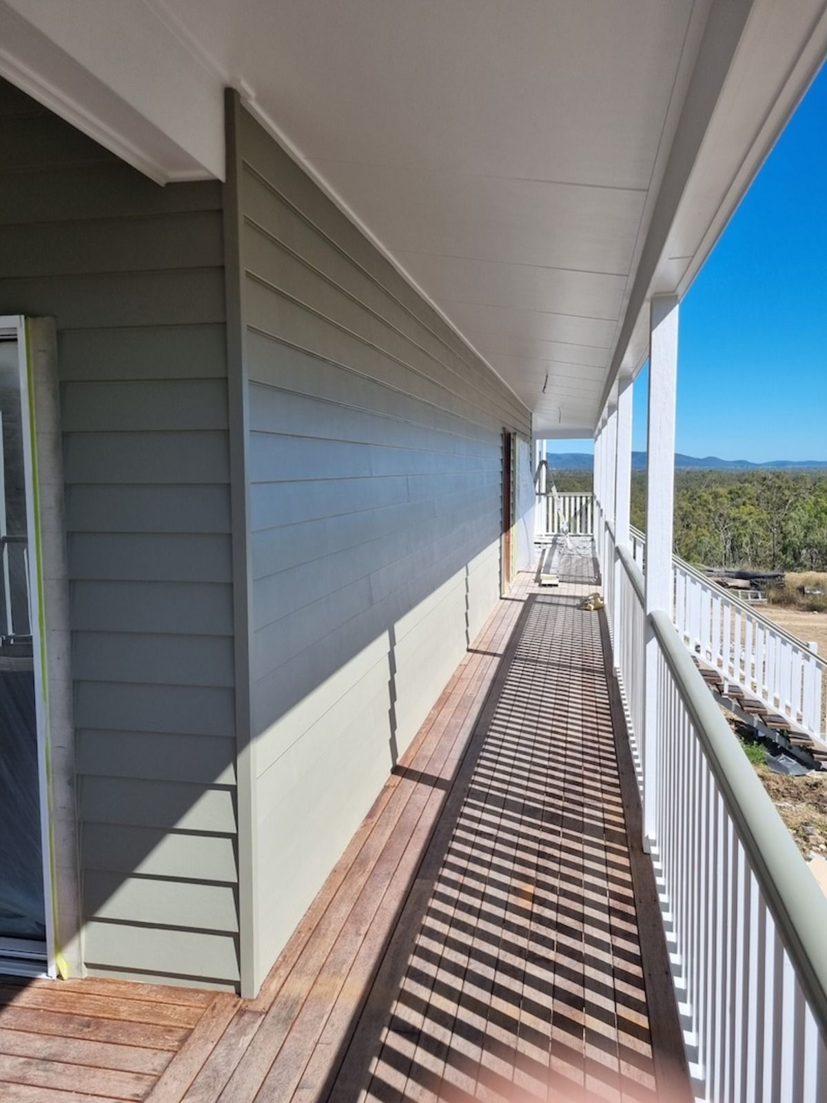 A Man Is Climbing a Roof with A Rope — A Brush With Colour in Hervey Bay, QLD