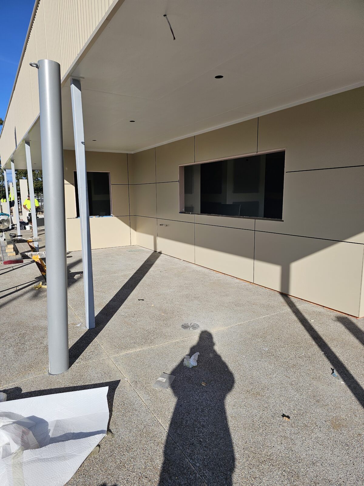 A Person Is Painting a Wall with A Paint Roller — A Brush With Colour in Craignish, QLD