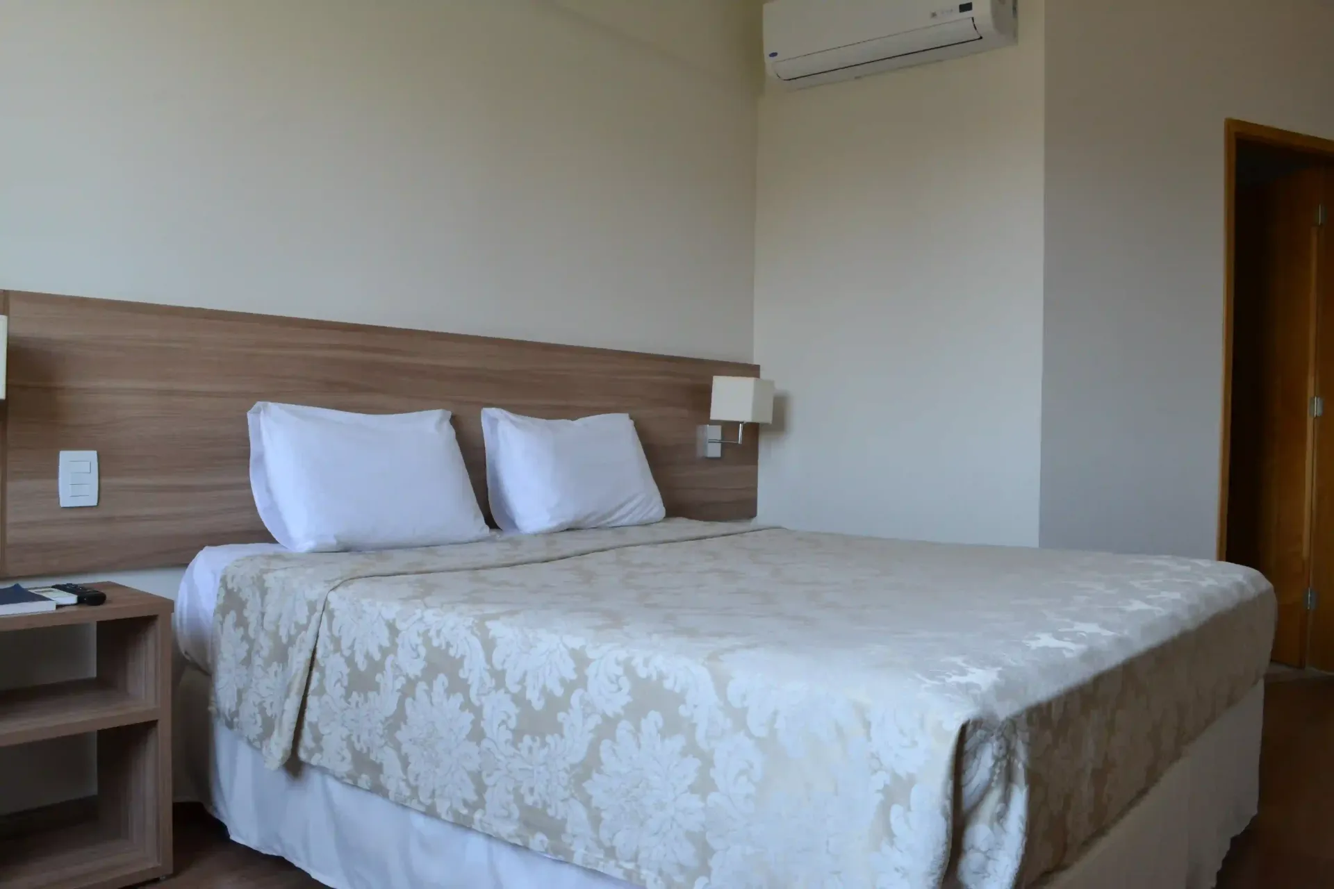 Um quarto de hotel com uma cama king size e uma mesa de cabeceira.-hotel-malibu-inn