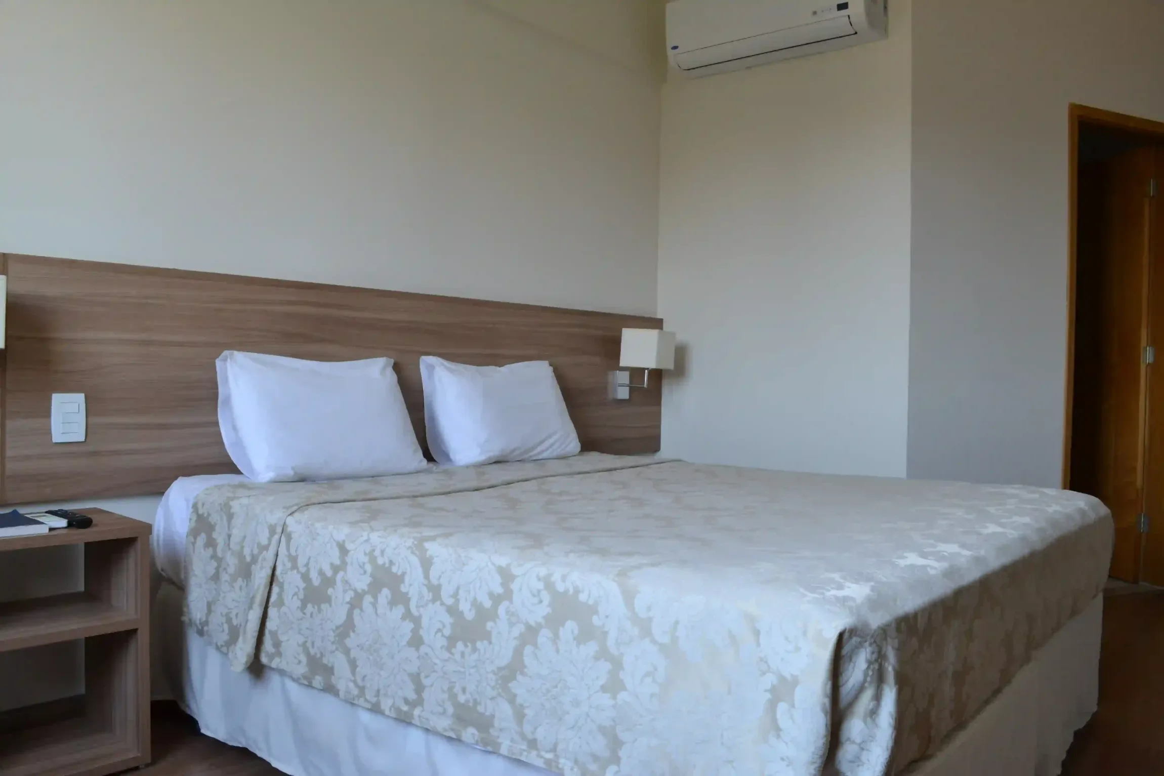 Um quarto de hotel com uma cama king size e uma mesa de cabeceira.-hotel-malibu-inn