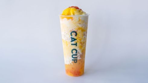 Tall orange-and-white C4 CUP drink with yellow topping, centered on a plain background