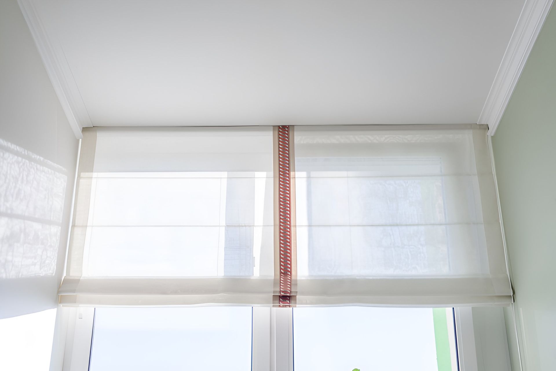 A White Blinds is Hanging on a Window — Homestead Blinds in Wodonga, VIC