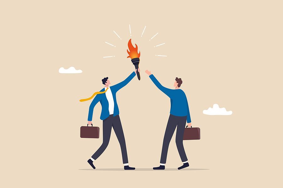Cartoon of two people in business attire, holding briefcases and one passing a torch to their chosen successor.