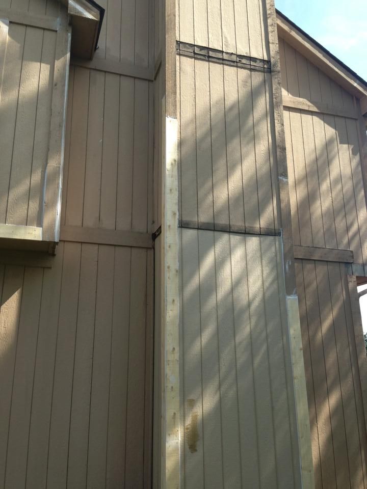 A wooden building with a chimney on the side of it