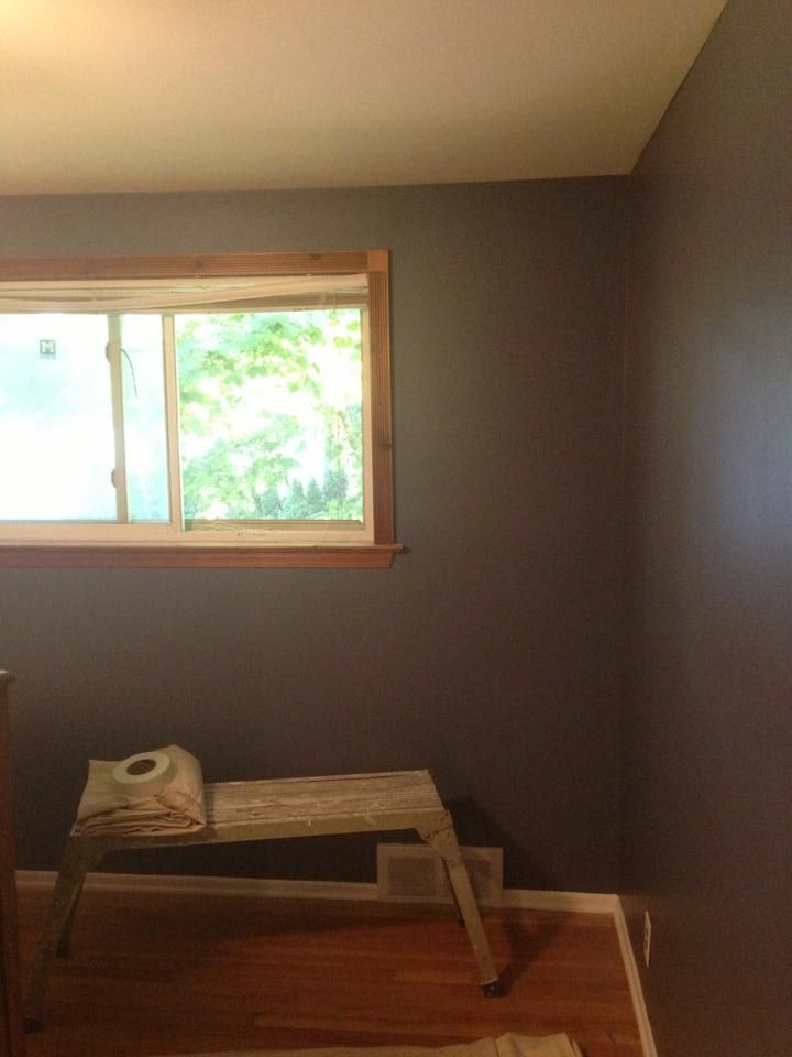 A room with a window and a bench in it.