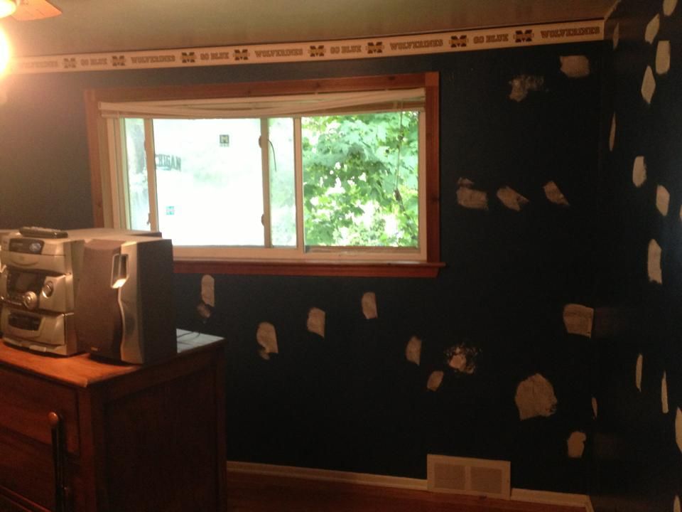 A room with a window and a dresser with a coffee maker on it