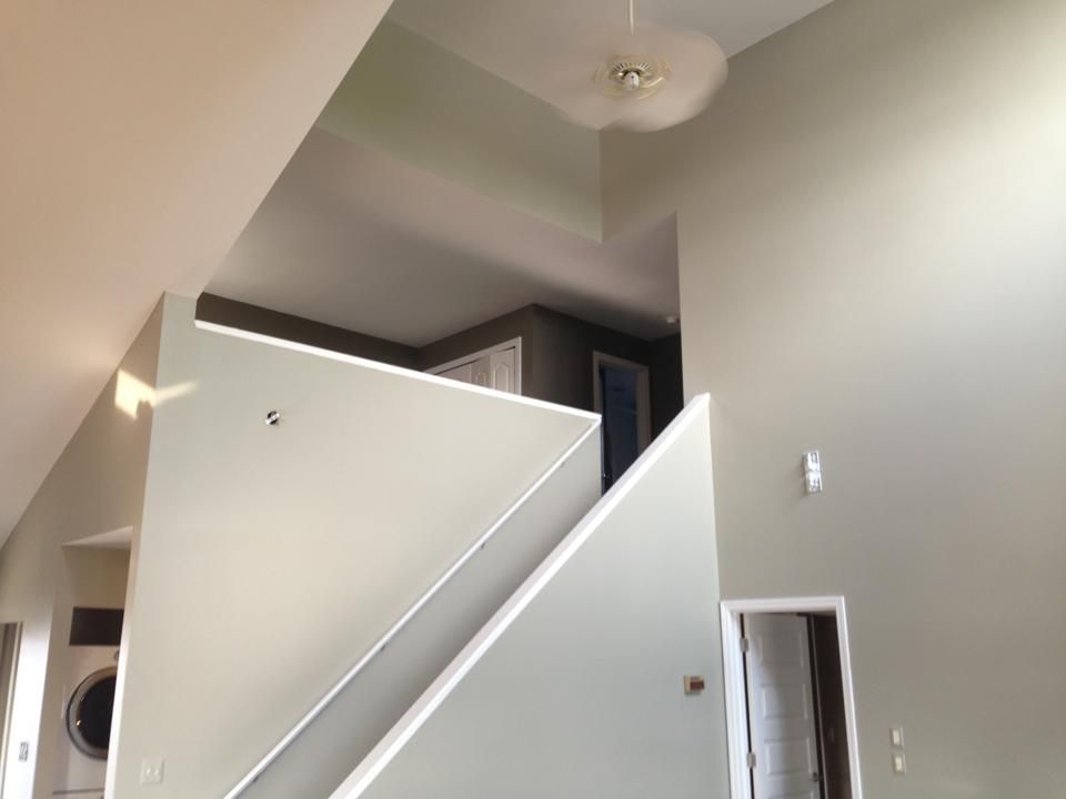 A staircase in a house with a ceiling fan hanging from the ceiling