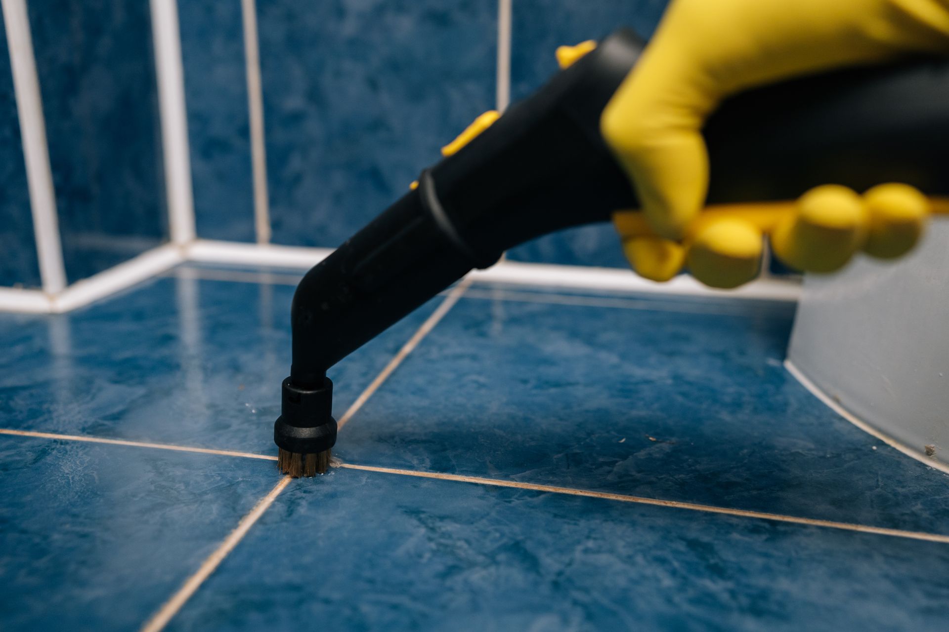 A room with a flooded floor and a vacuum cleaner on the floor.