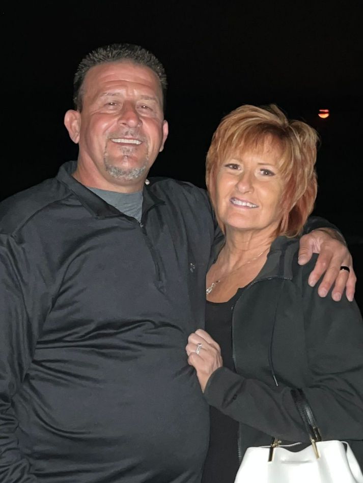 A man and a woman are posing for a picture together