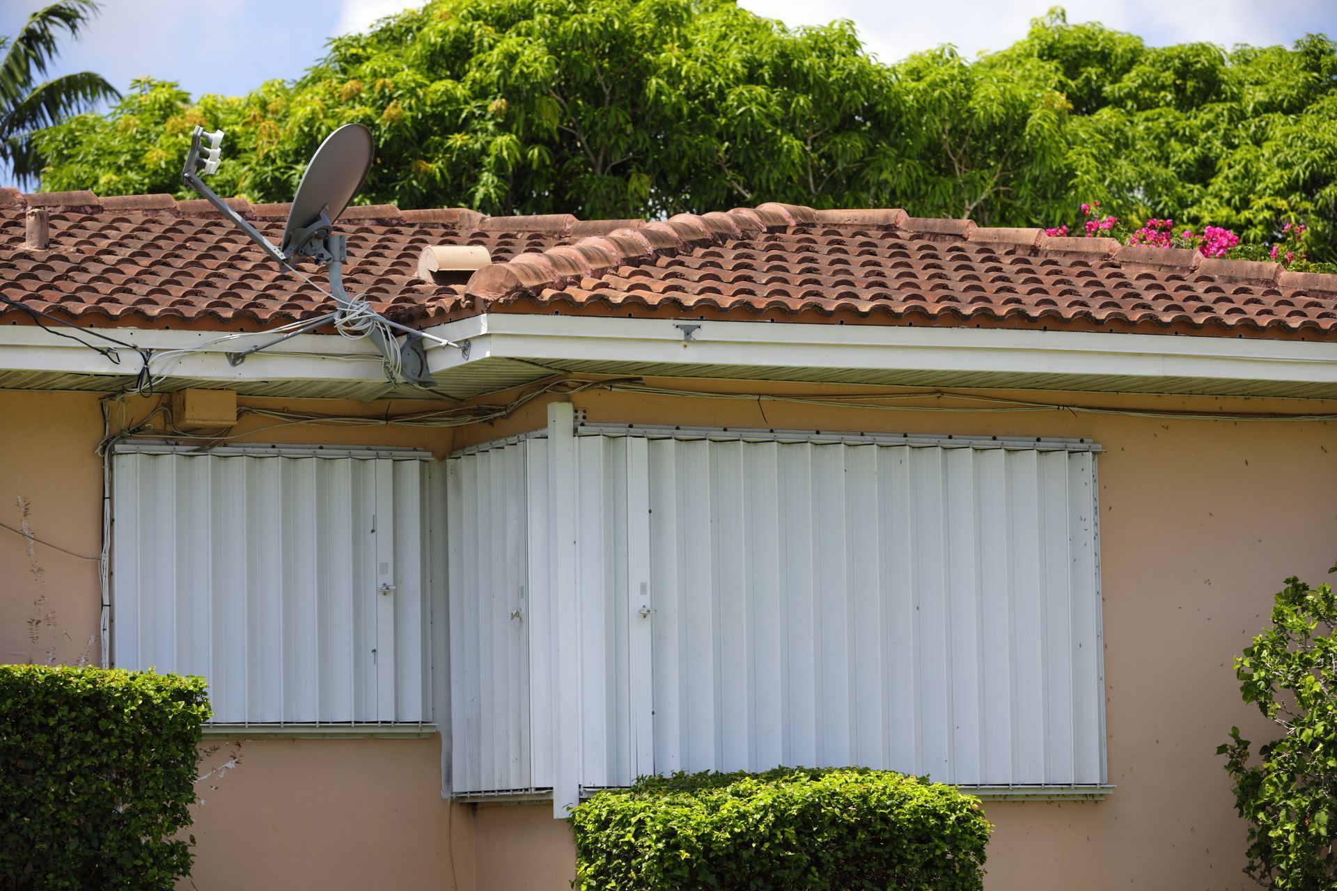 A home with storm shutters installed on its windows. A home with storm shutters installed on its windows.