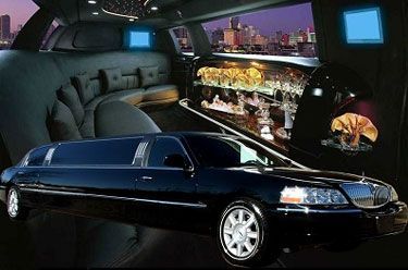 Black limousine interior and exterior; luxurious, with bar area, and city skyline view.