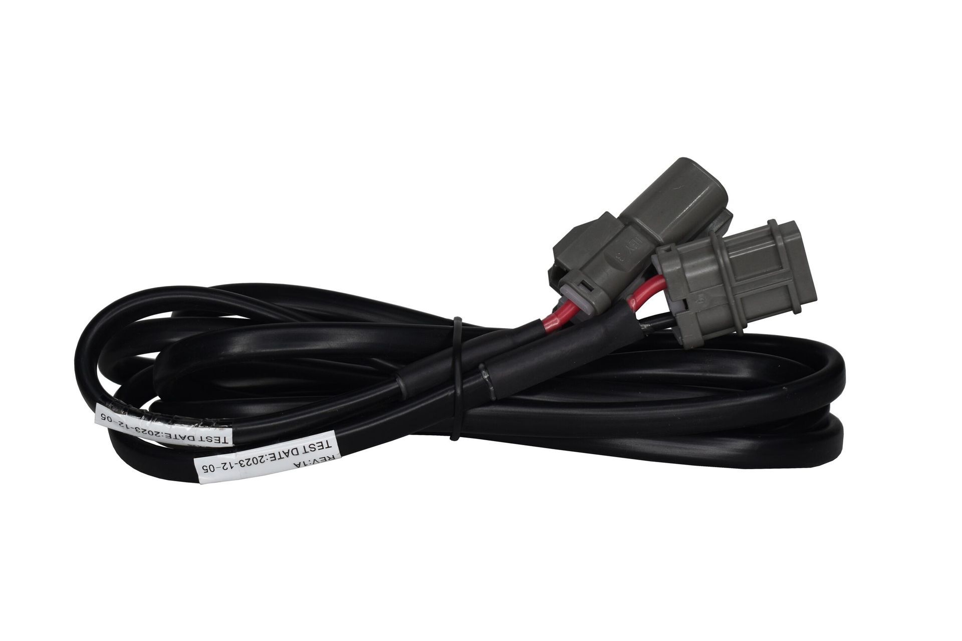 Black electrical power cable with two gray connectors, coiled on a white background