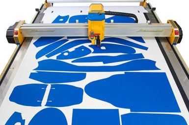 Large-format printer printing blue graphics onto white material