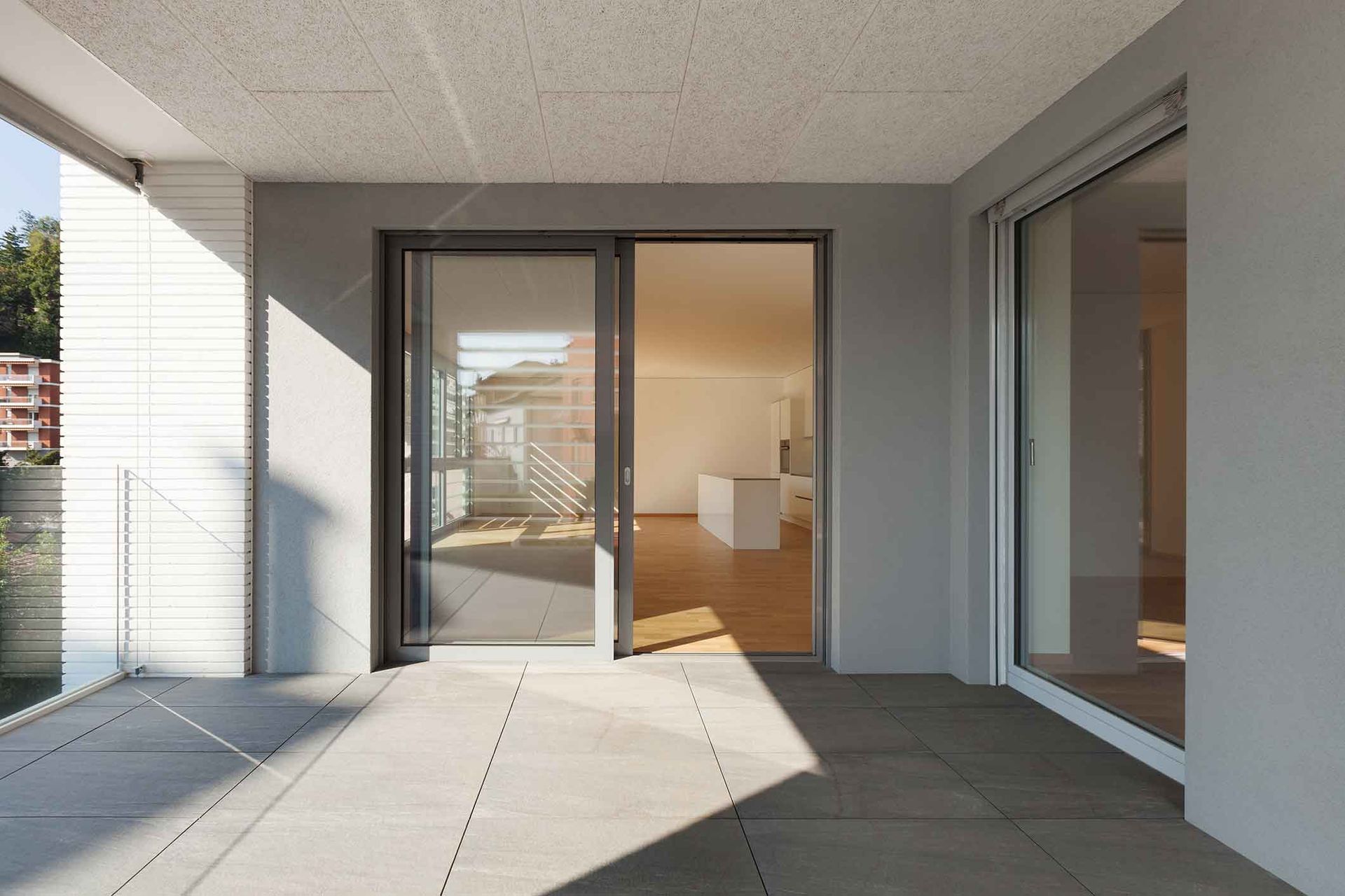 A balcony with sliding glass doors leading to a living room