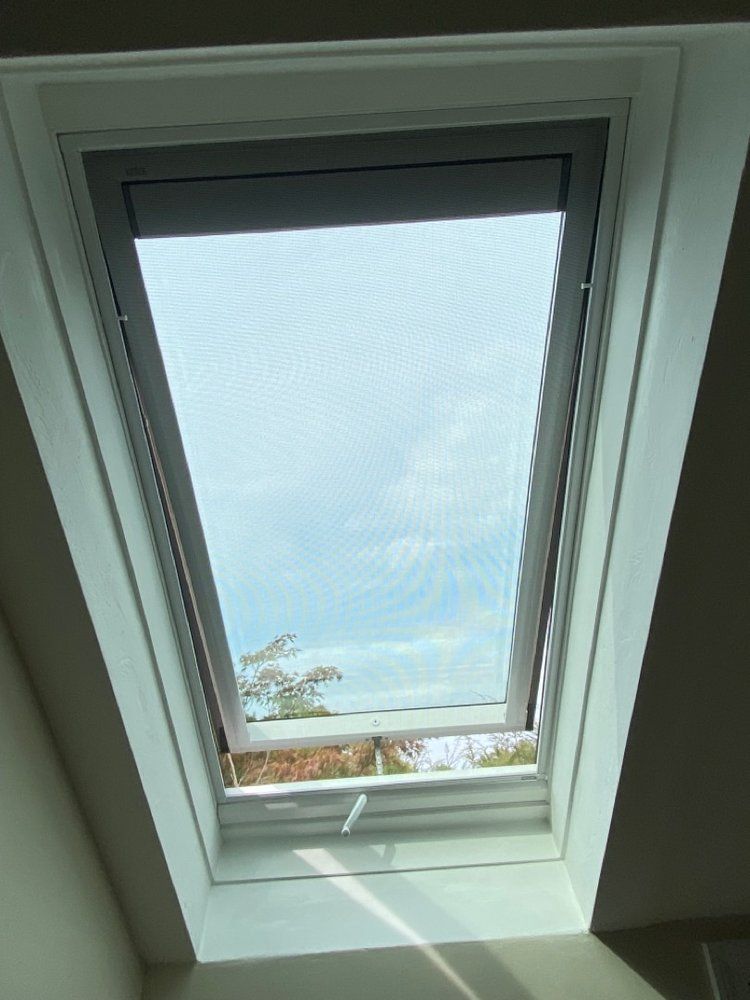 The skylight is open and looking out to the sky