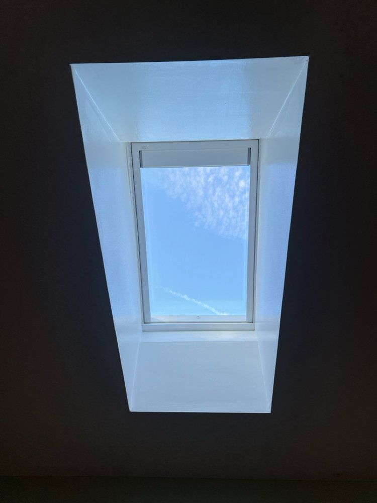 A skylight with a blue sky behind it