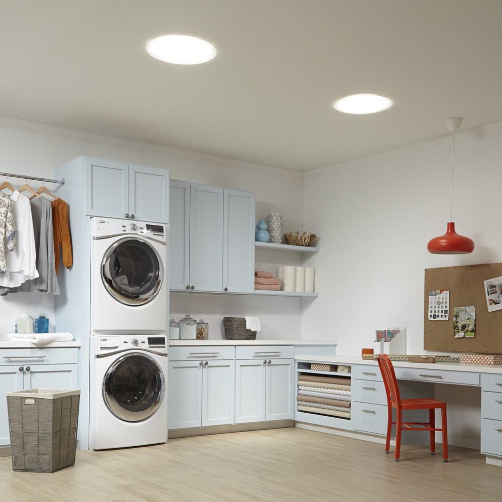 A laundry room with a washer and dryer stacked on top of each other
