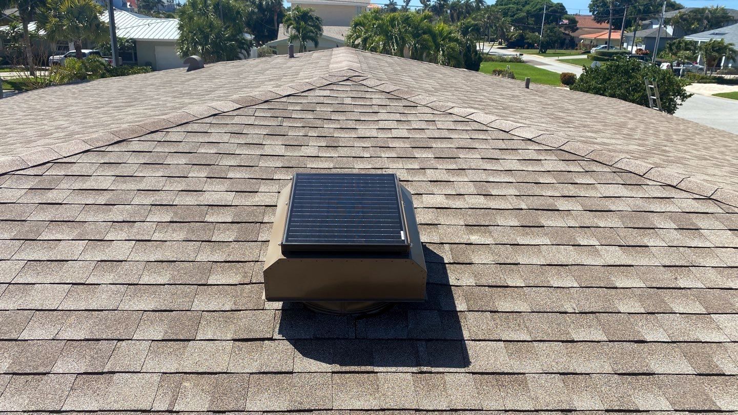 A roof with a solar panel on top of it.