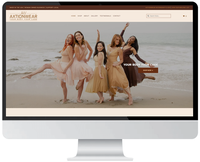 A computer screen shows a group of women dancing on the beach.