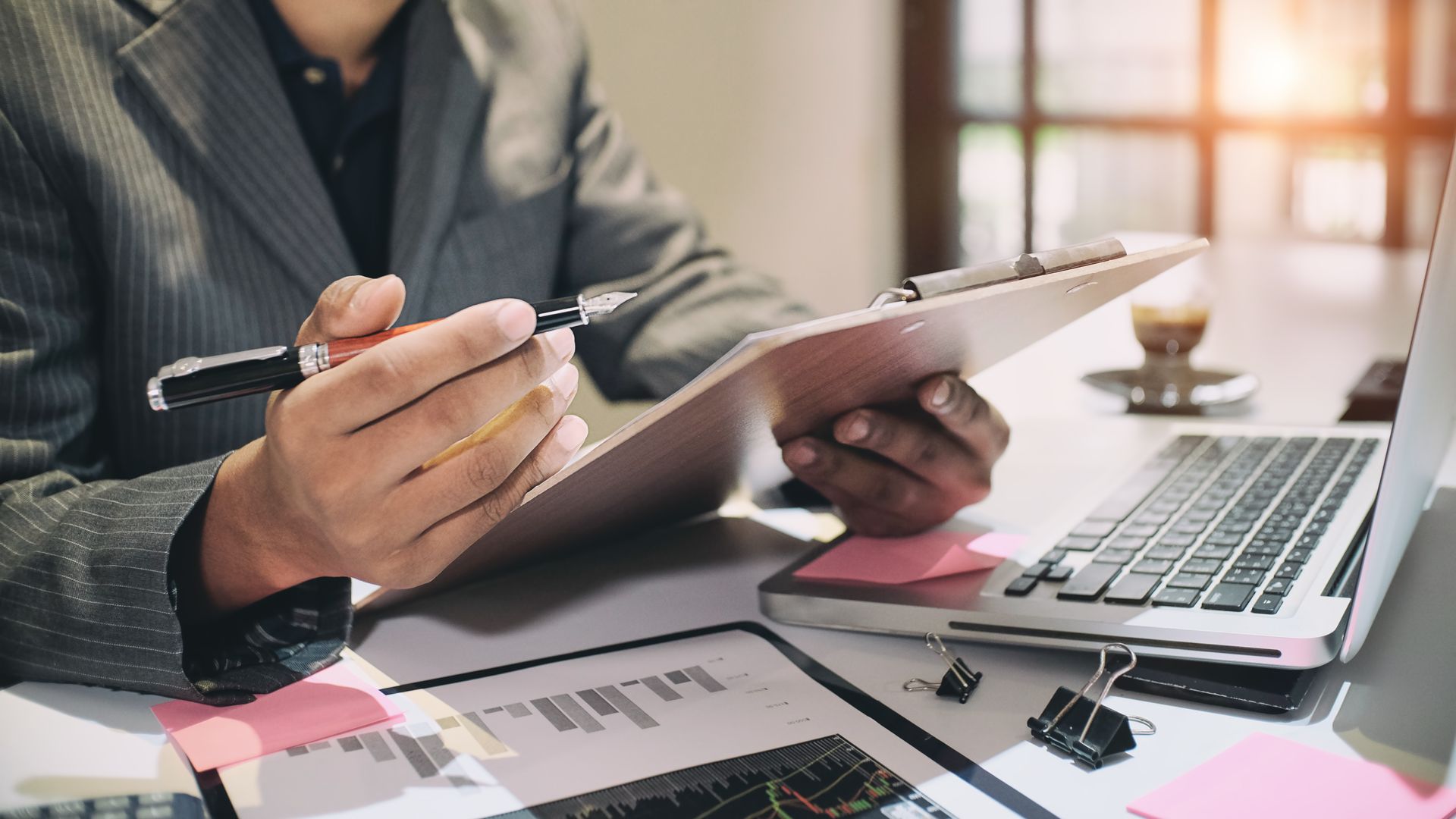 Auditor analyzing data sheets with an expert corporate CPA service.
