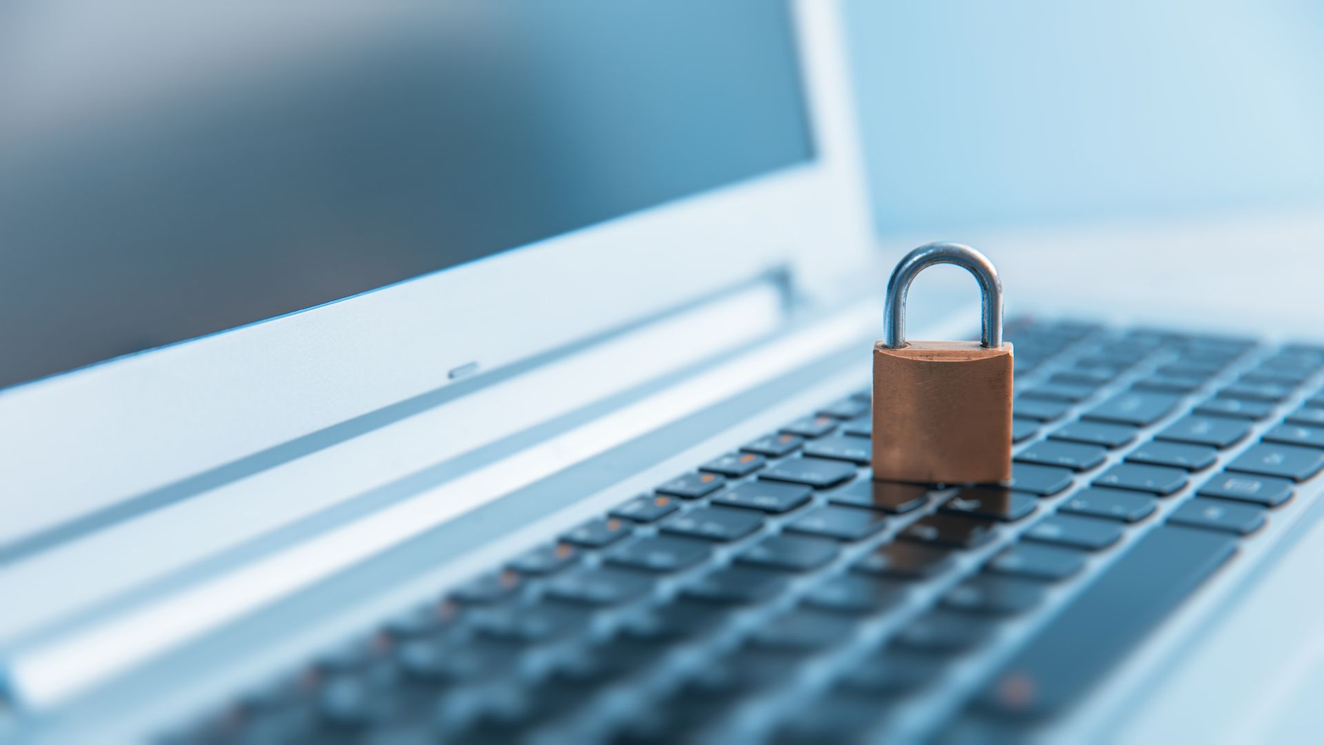 Padlock on a laptop keyboard, symbolizing cybersecurity and data protection