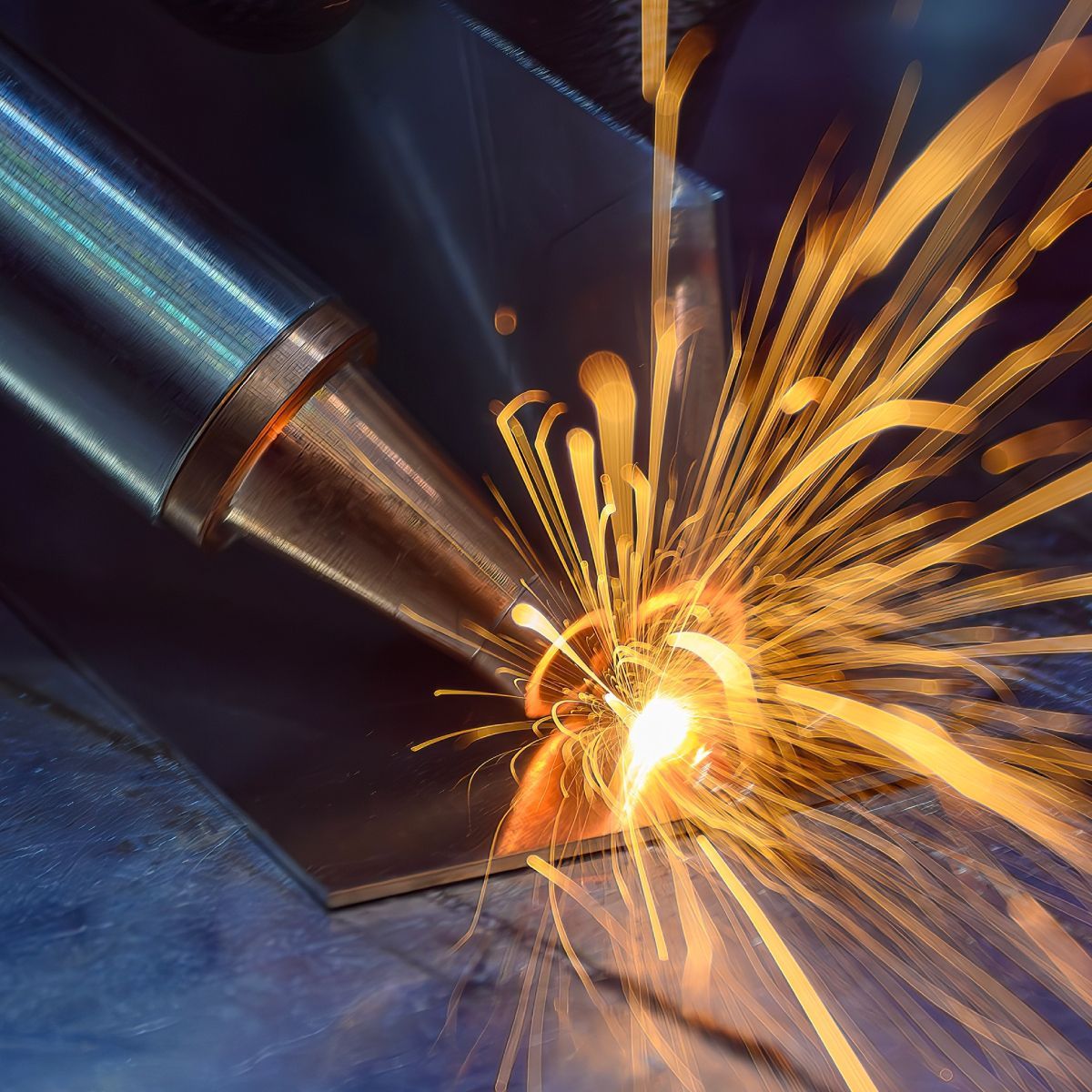 A person is welding a piece of metal with sparks coming out of it