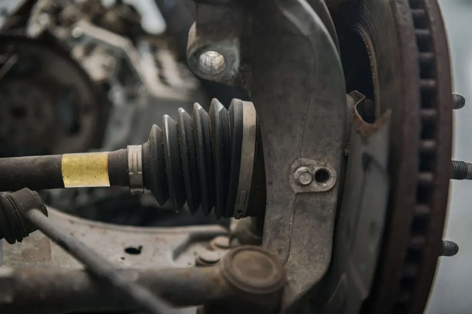 A close up of a drive shaft on a car.