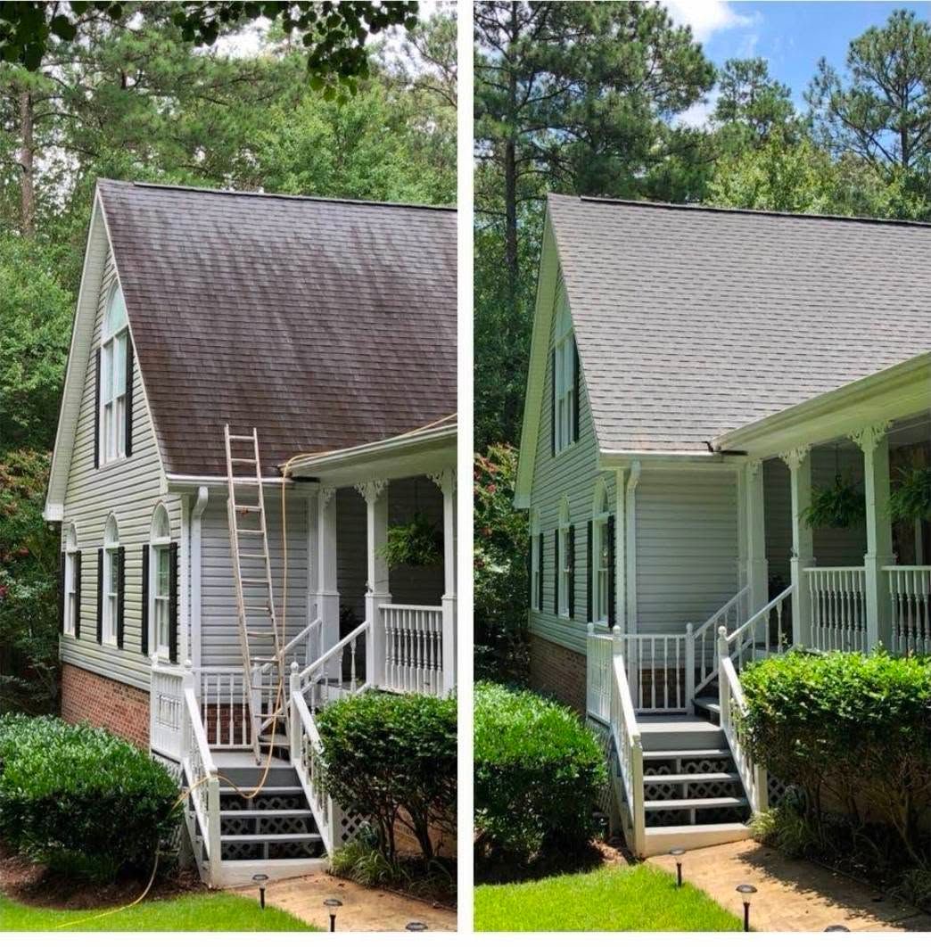 Blue tarp covering roof damage on a shingled house roof beneath trees
