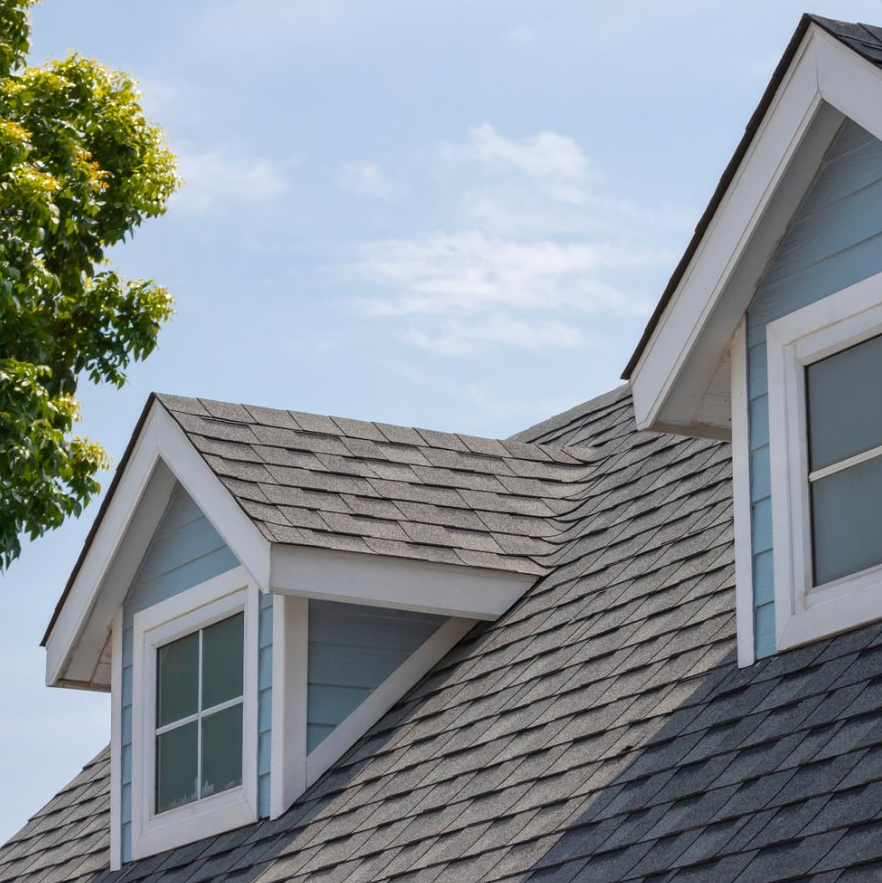 A blue house with a gray roof and two windows