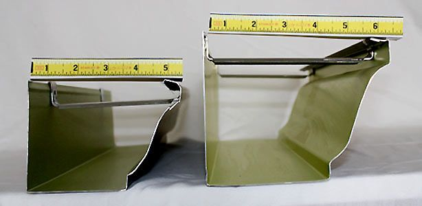 Two metal gutters are being measured with a tape measure