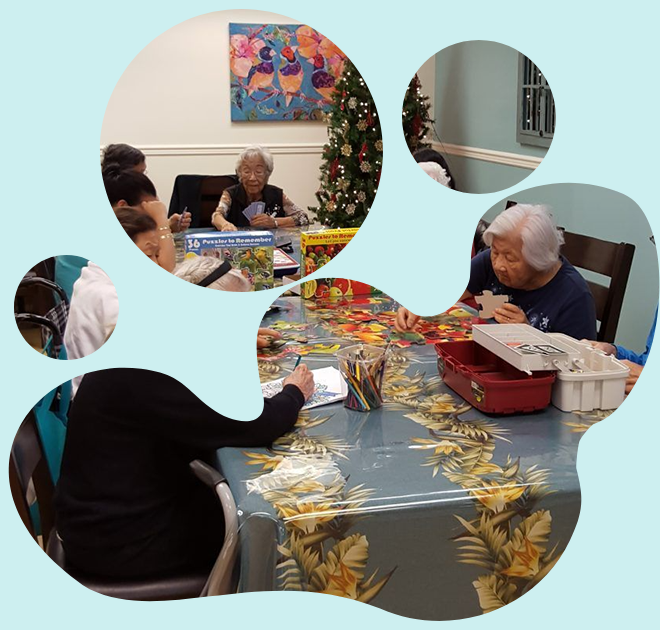 A group of people are sitting around a table with a christmas tree in the background