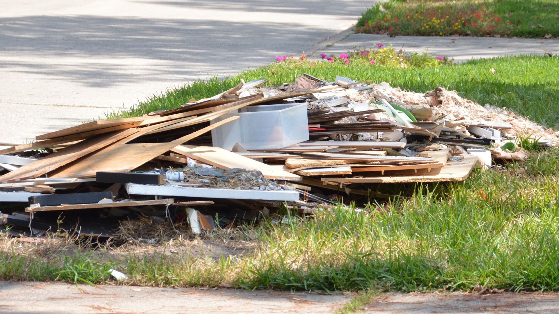 A pile of wood is sitting on the side of the road