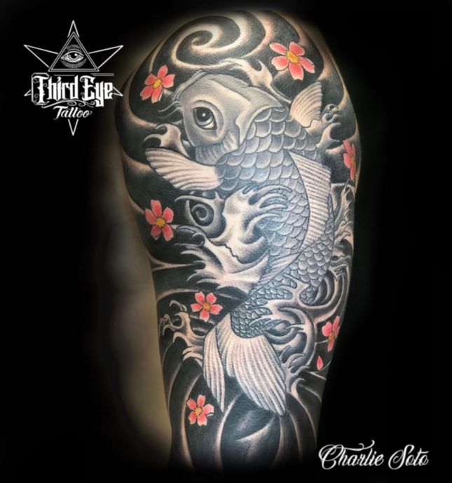 Koi fish tattoo on arm, in grayscale, with cherry blossoms and waves.