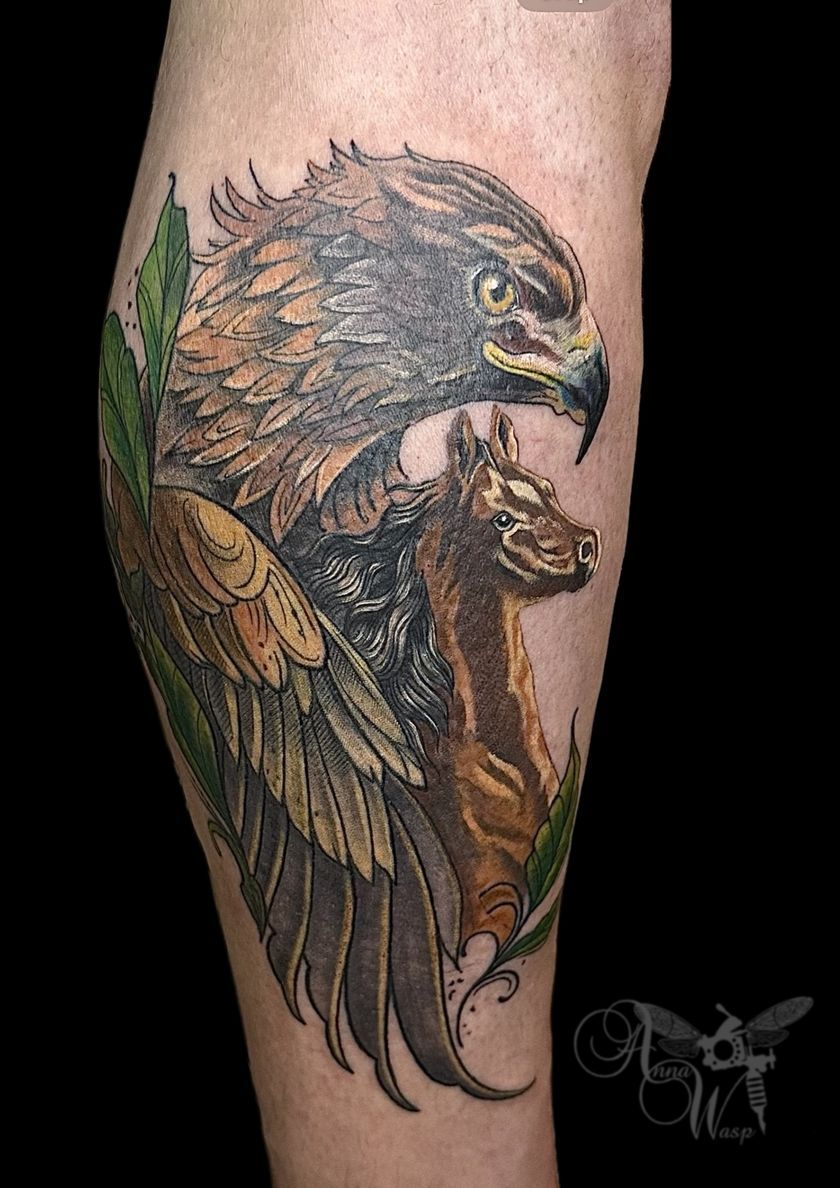 Tattoo of an eagle with a deer on a leg. Brown and gold tones.