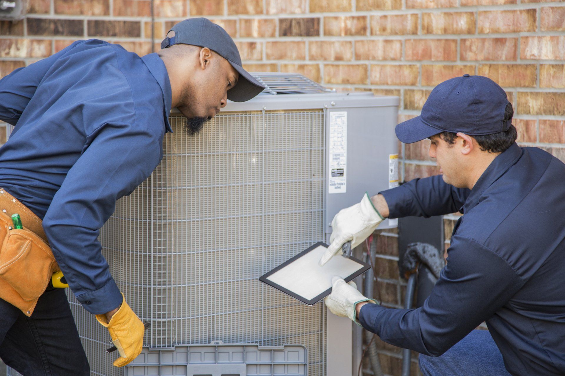 Air Conditioner Repairmen At Work — Rolla, MO – Arnco Mechanical LLC