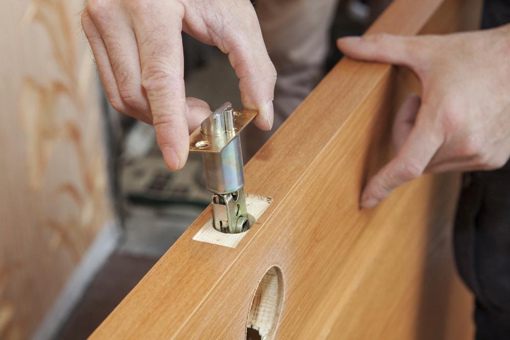 Man Repairing Door Lock System — Locksmith in Townsville, QLD