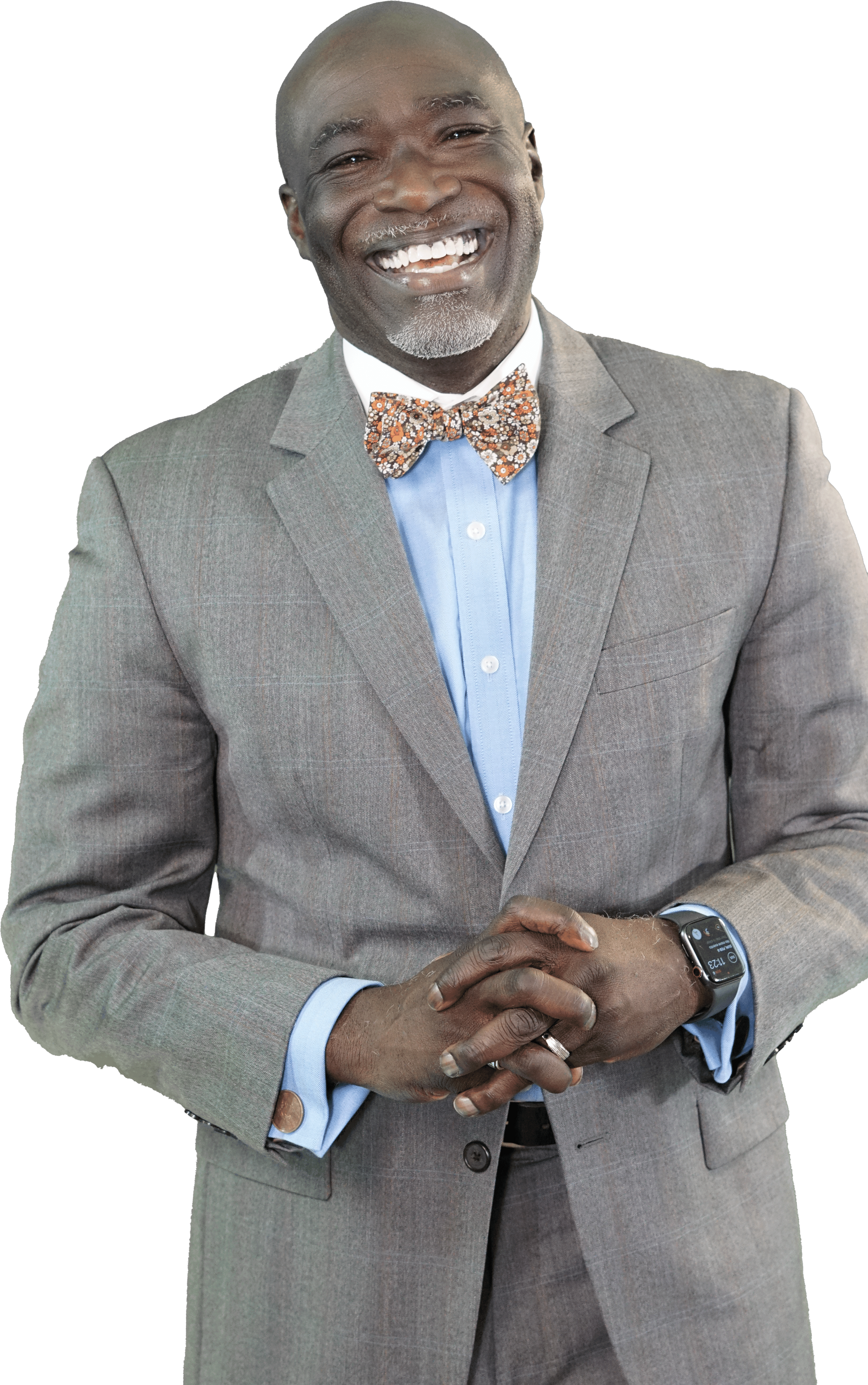 A man in a suit and bow tie is smiling.