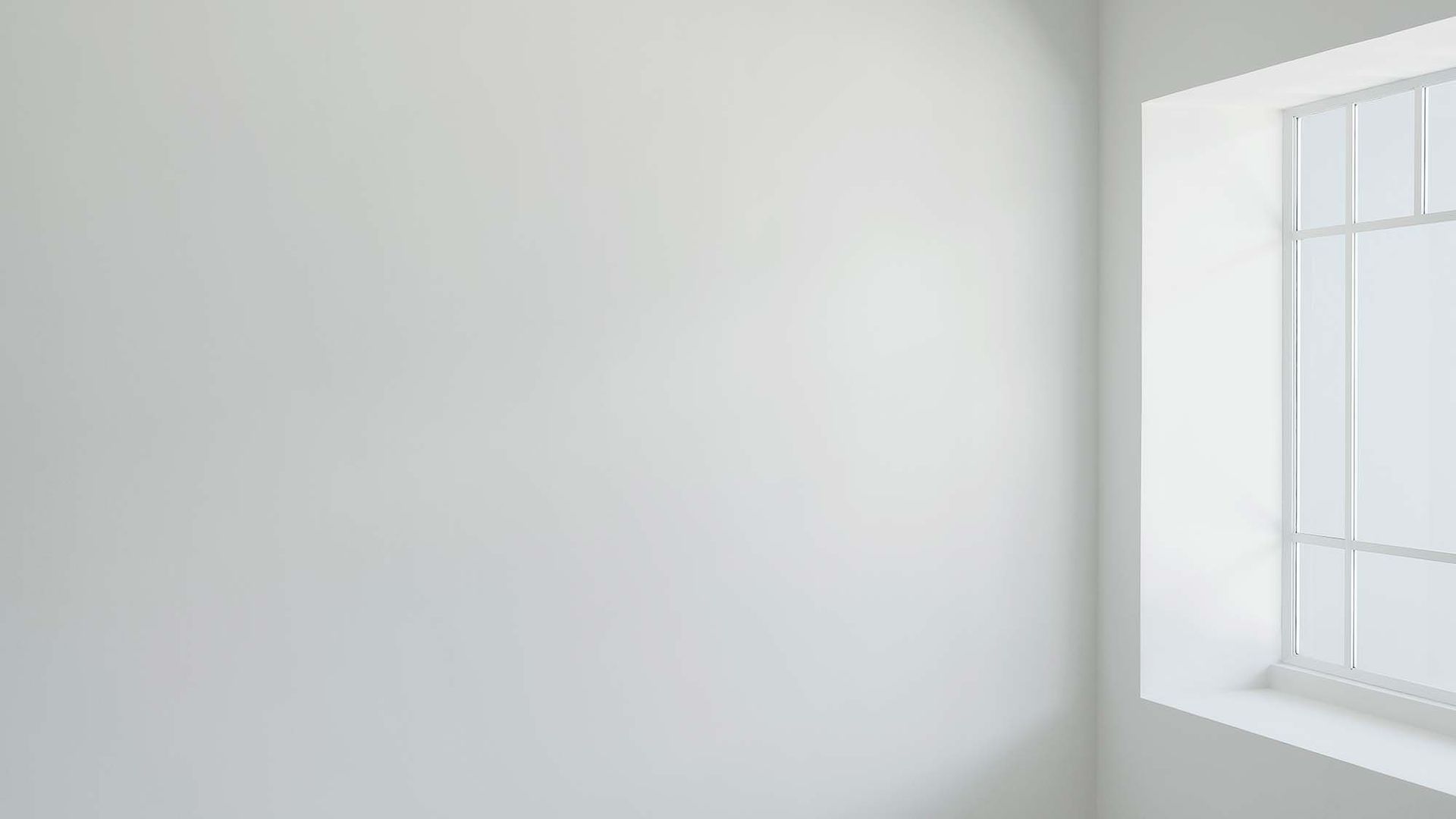 Blank white wall with a small square window on the right side